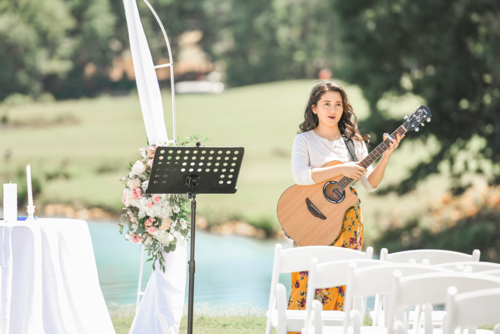 Wedding musician plays guitar before ceremony