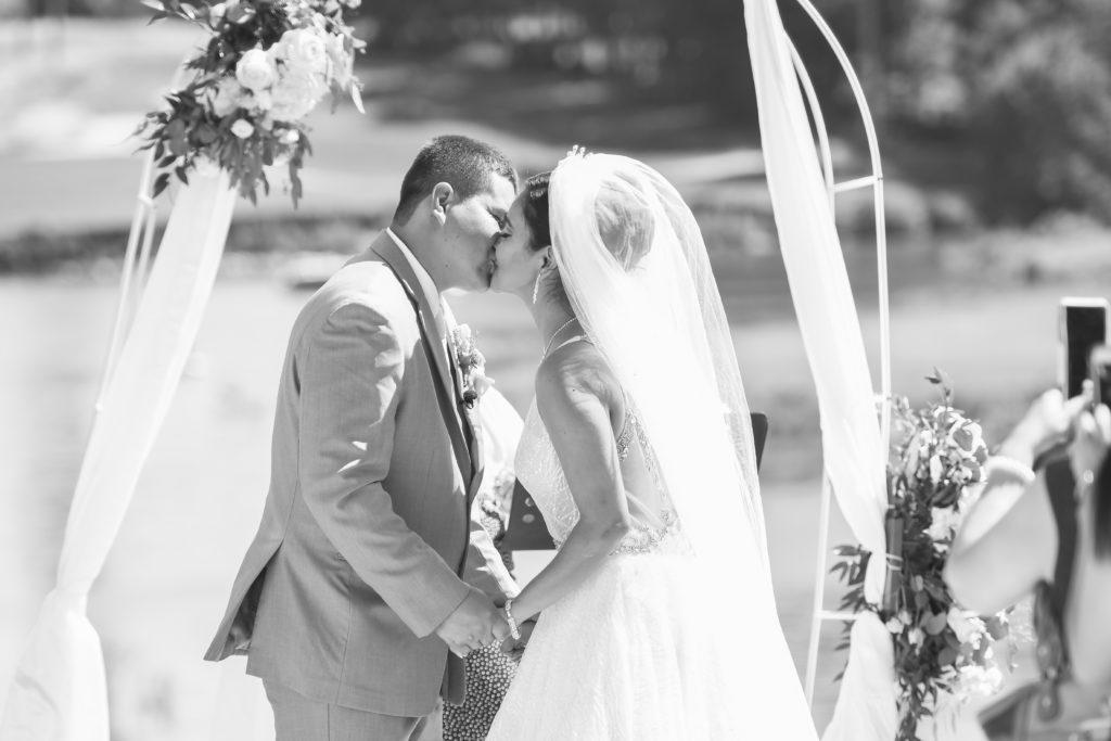 Bride and groom share their first kiss as man and wife at their Charlotte NC wedding