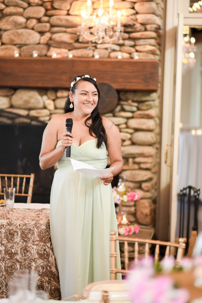 The Maid of Honor laughs as she gives the toast