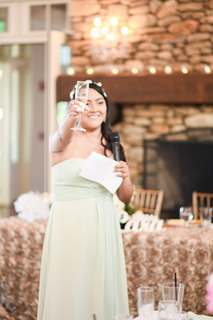 The Maid of Honor laughs as she gives the toast