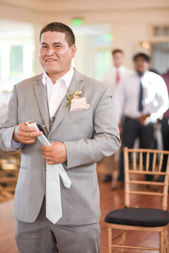 The groom prepares to throw the garter to a group of waiting men