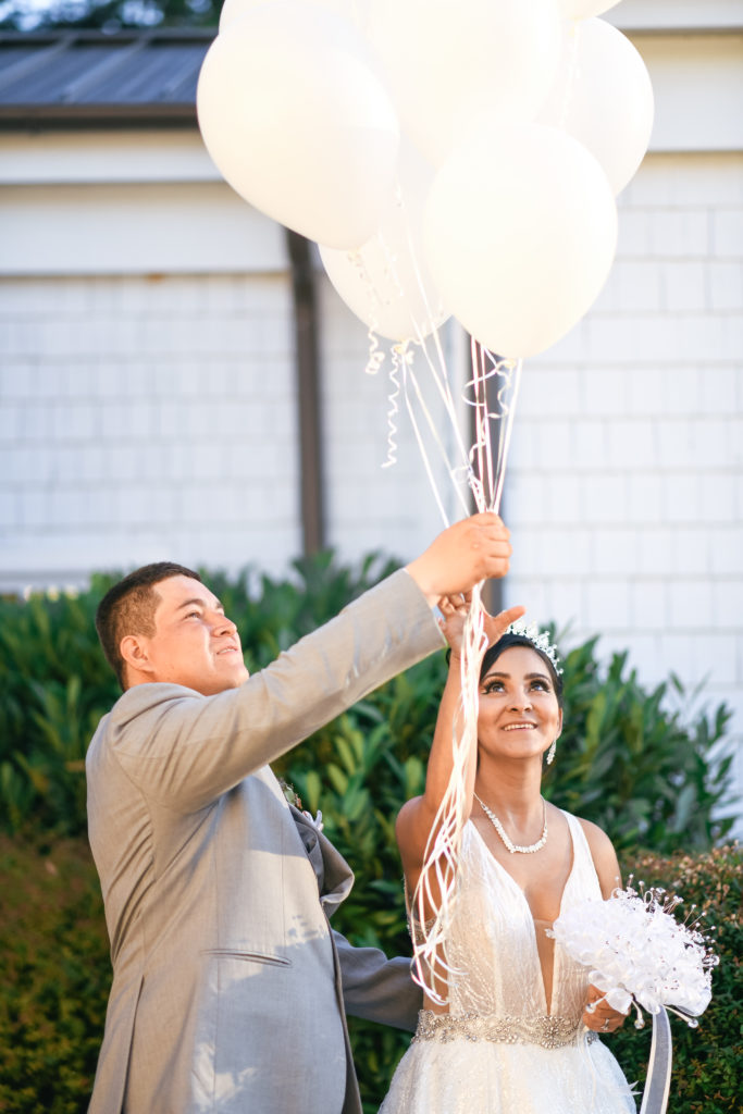 Bride and groom release balloons