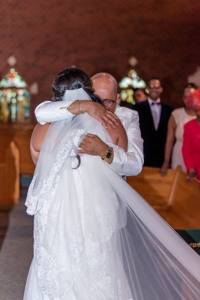 Father of the bride gives his daughter away at her wedding
