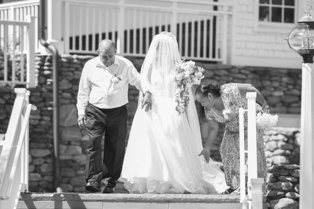 Father and Mother of the bride prepare to walk their daughter down the aisle