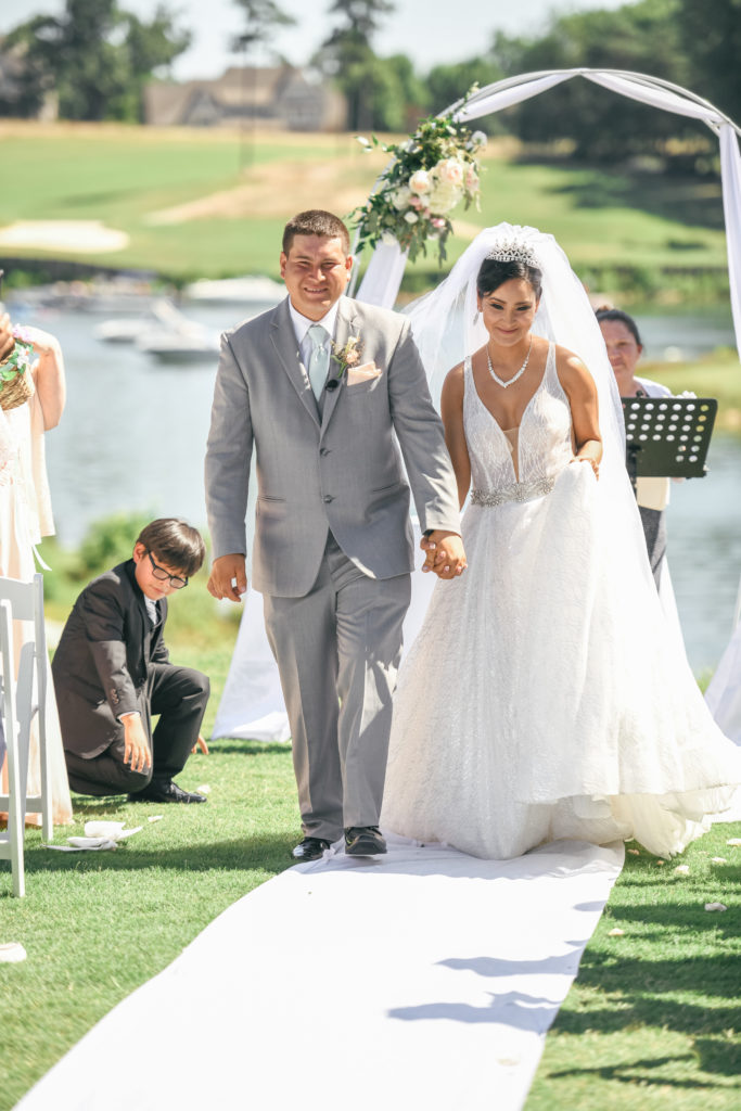 Bride and groom walk back down the aisle after being pronounced husband and wife