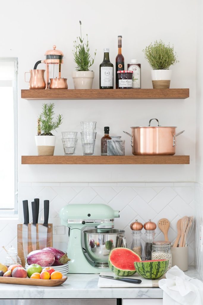 Kitchen design with open shelving and mint and copper accents