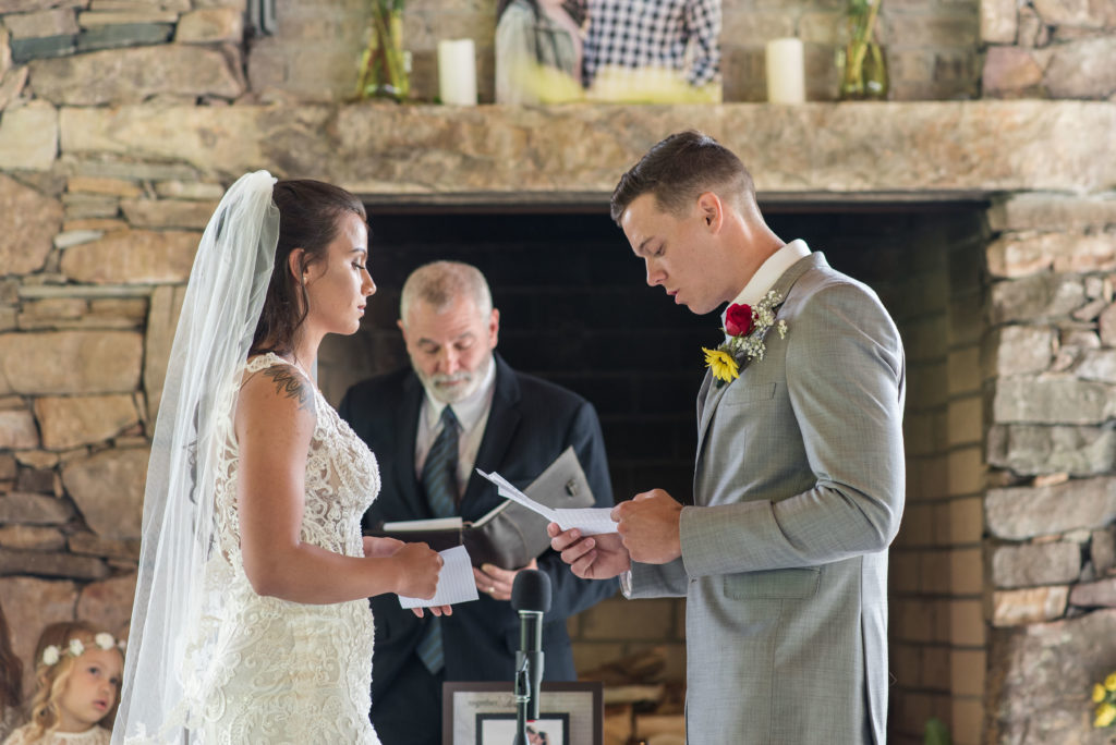 the bride and groom exchange vows at their Hemlock Barn wedding near Boone NC