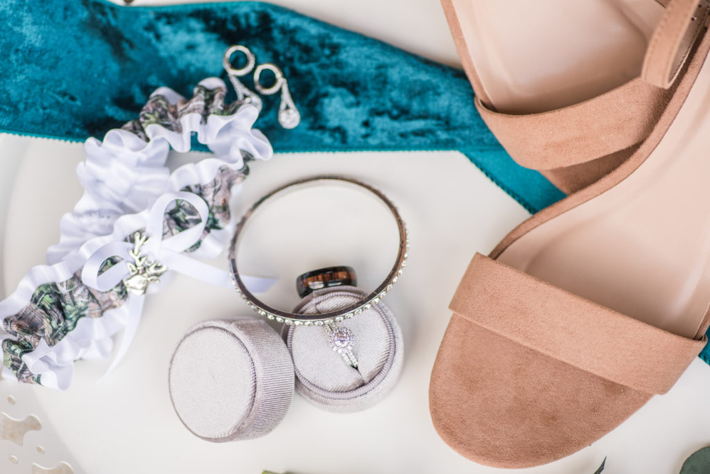 Bridal details: bride's shoes, rings, garter, and jewelry