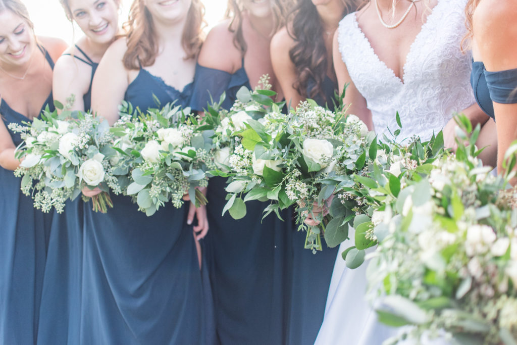 Charlotte Floral Designers at Heatherly Event Design create timeless white and eucalyptus bouquets for this bridal party 