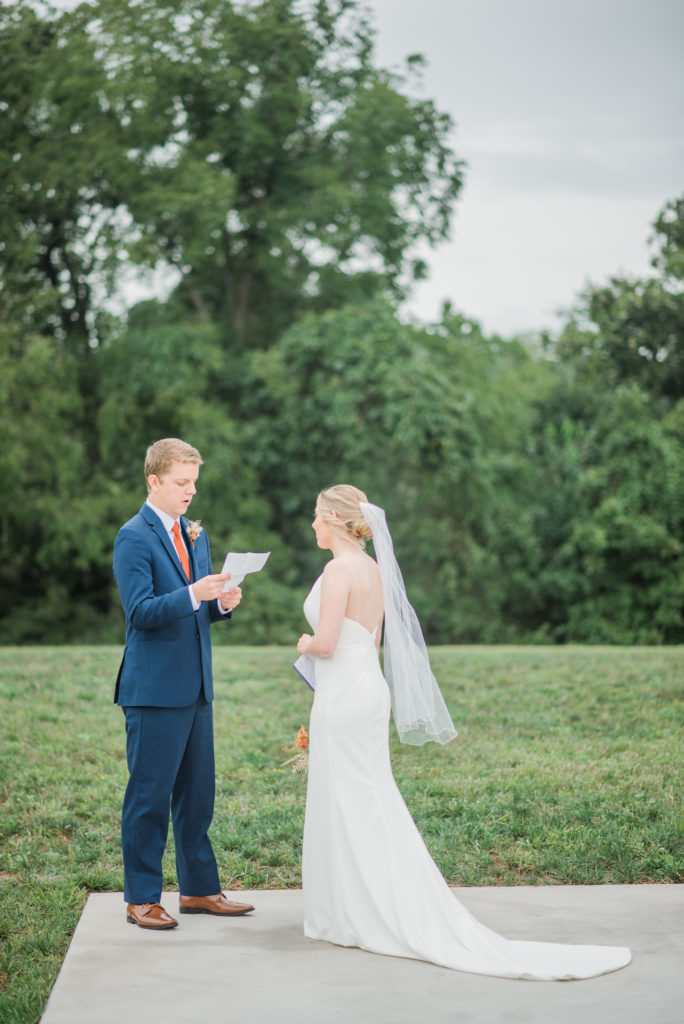 Bride and groom exchange personal vows during their first look at their Hazelwood weddings autumn wedding
