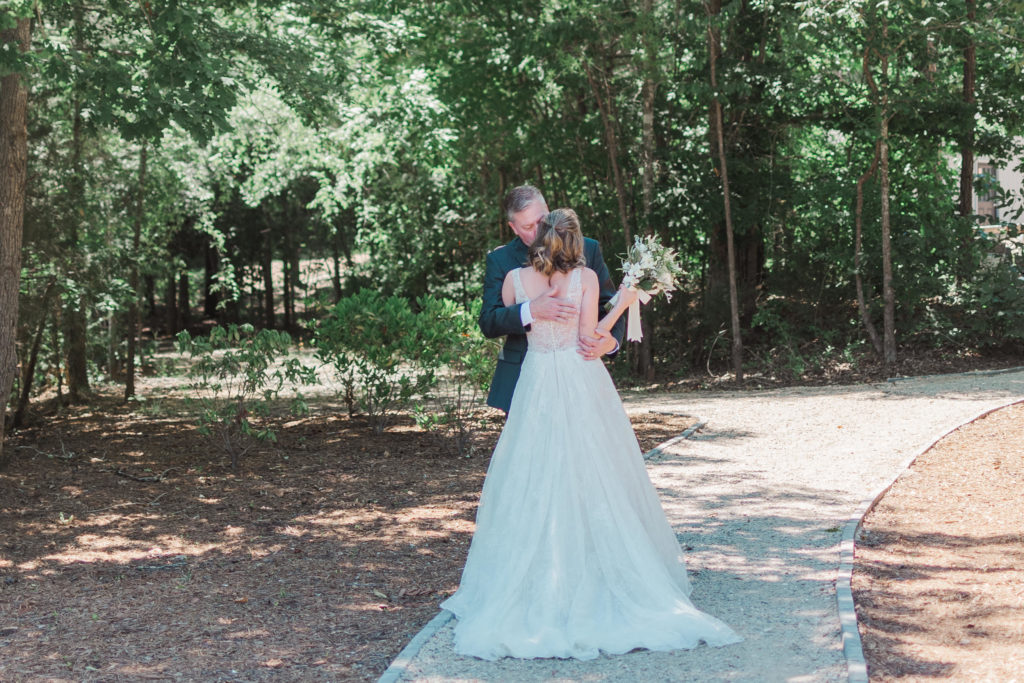 Bride and Father of the bride share a first look before Splendor Pond Wedding venue near Charlotte NC